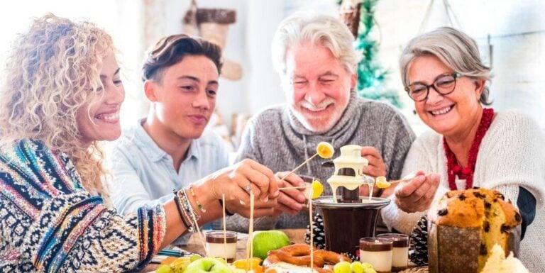 Elderly Couple Happily Eating With Their Loved Ones in Assisted Living Facility