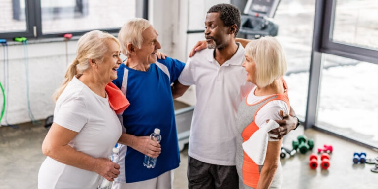 Elderly Group Standing Together After Indoor Workout Session at an Assisted Living Facility