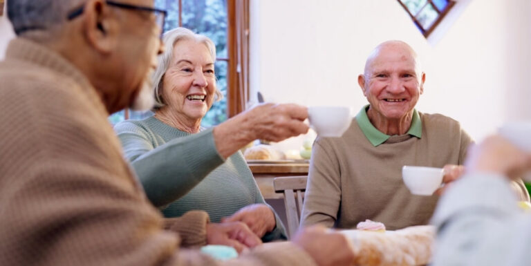 Seniors Enjoying Coffee and Snacks Together at Assisted Living Facility in Omaha