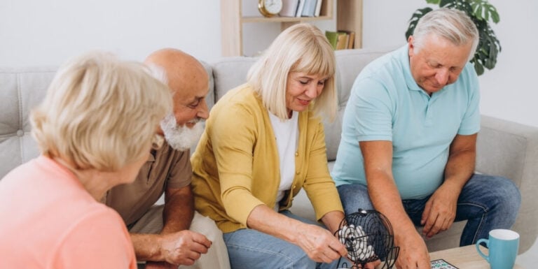 Group of Seniors Playing Bingo Together Indoors at an Assisted Living Facility