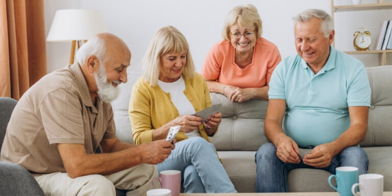 Group of Seniors Playing Cards Together Indoors at an Assisted Living Facility