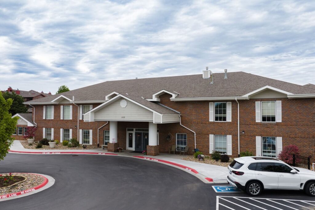 Covered Brick Entrance And Landscaped Front Grounds At Assisted Living Facility
