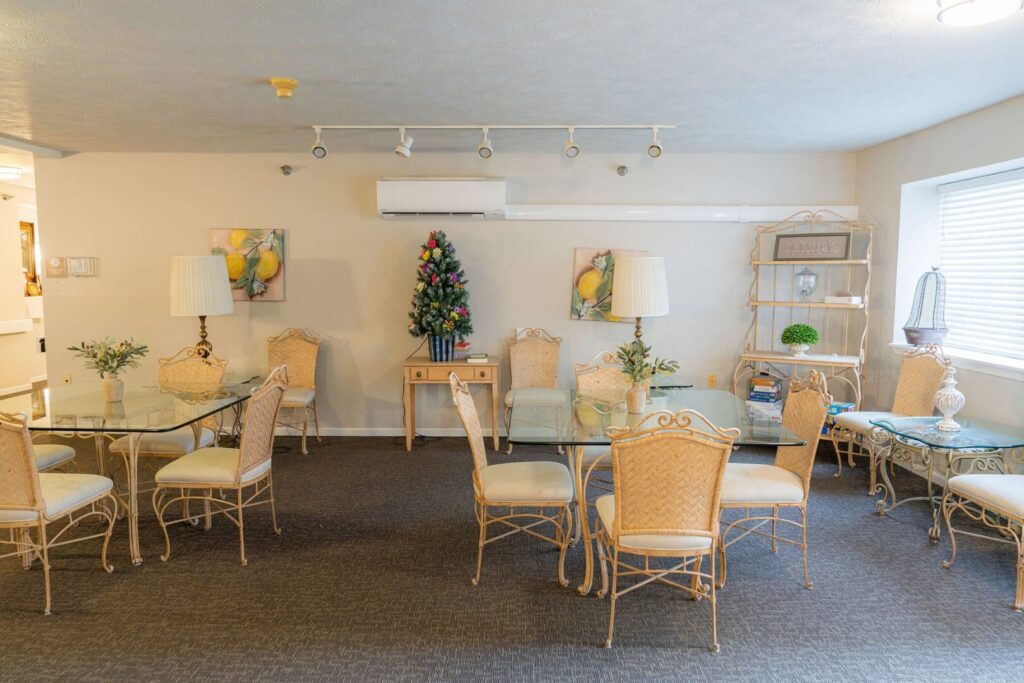 Bright Private Dining Room With Elegant Glass-Top Tables At Assisted Living Facility