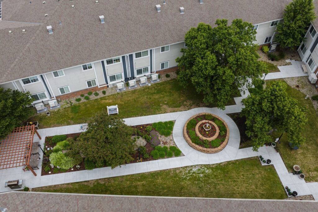 Lush Courtyard Garden With Circular Fountain Walkway At Assisted Living Facility