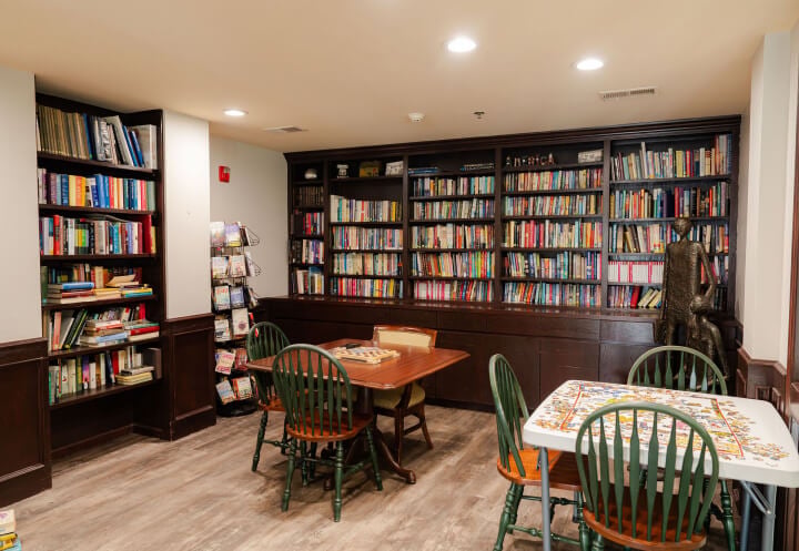Resident Library With Tables and Books at Assisted Living Community in Omaha NE Resident Library With Tables and Books at Assisted Living Community in Omaha NE