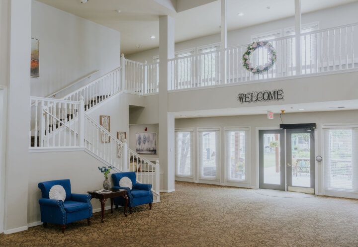 Two-Story Lobby With Staircase at Assisted Living Facility in Omaha NE Two-Story Lobby With Staircase at Assisted Living Facility in Omaha NE