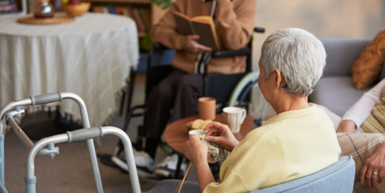 Elderly Residents Relaxing With Books and Knitting at Assisted Living Facility
