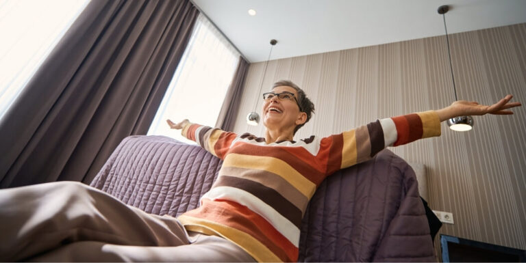 Joyful Woman Relaxing in Room at Assisted Living Facility