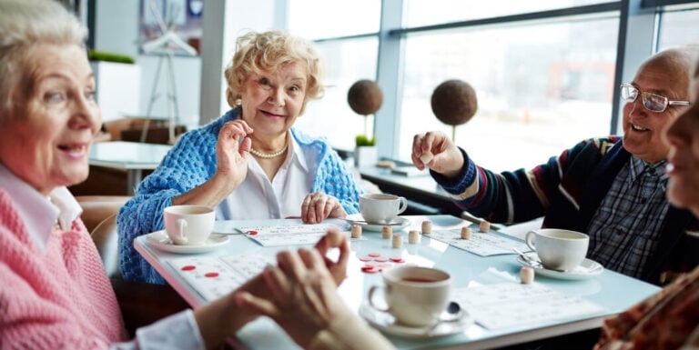 Elderly Friends Playing Bingo Together in Assisted Living Facility